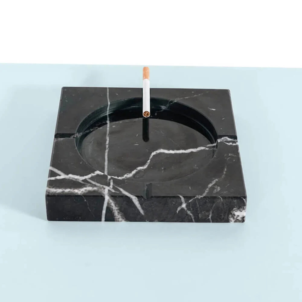 Black marble ashtray with a cigarette use