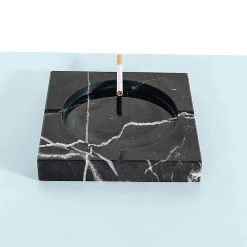 Black marble ashtray with a cigarette use