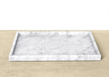 Marble patterned tray on a beige surface