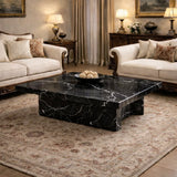 Luxurious living room with marble coffee table, beige sofas, and decorative lamps.