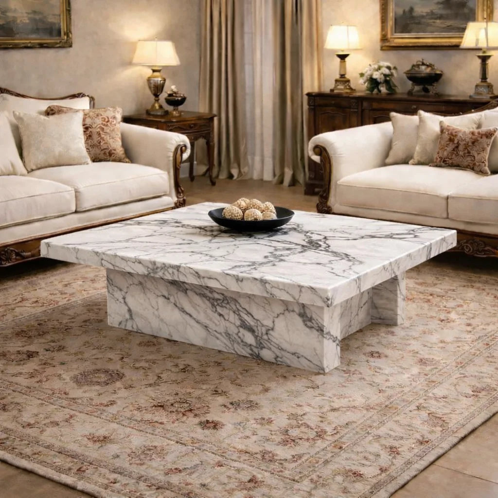 Living room with marble coffee table, beige sofas, and decorative elements.