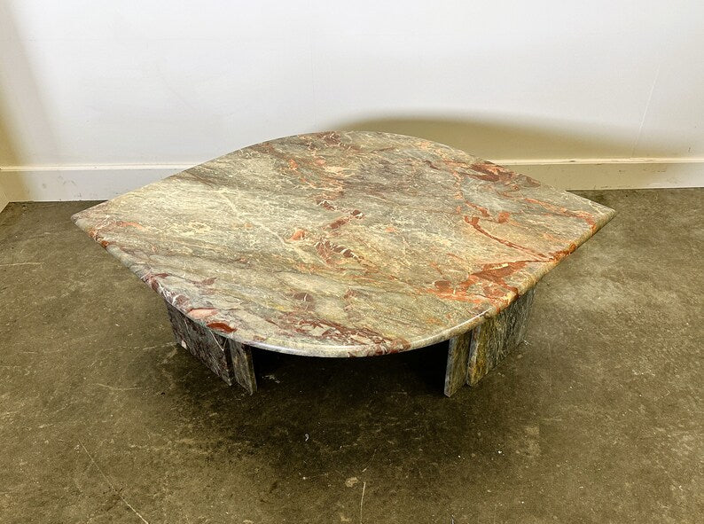 Hexagonal stone table with a natural pattern on a concrete floor.